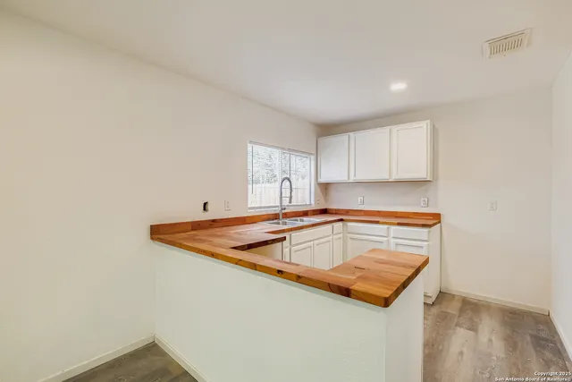 a kitchen with a sink and cabinets