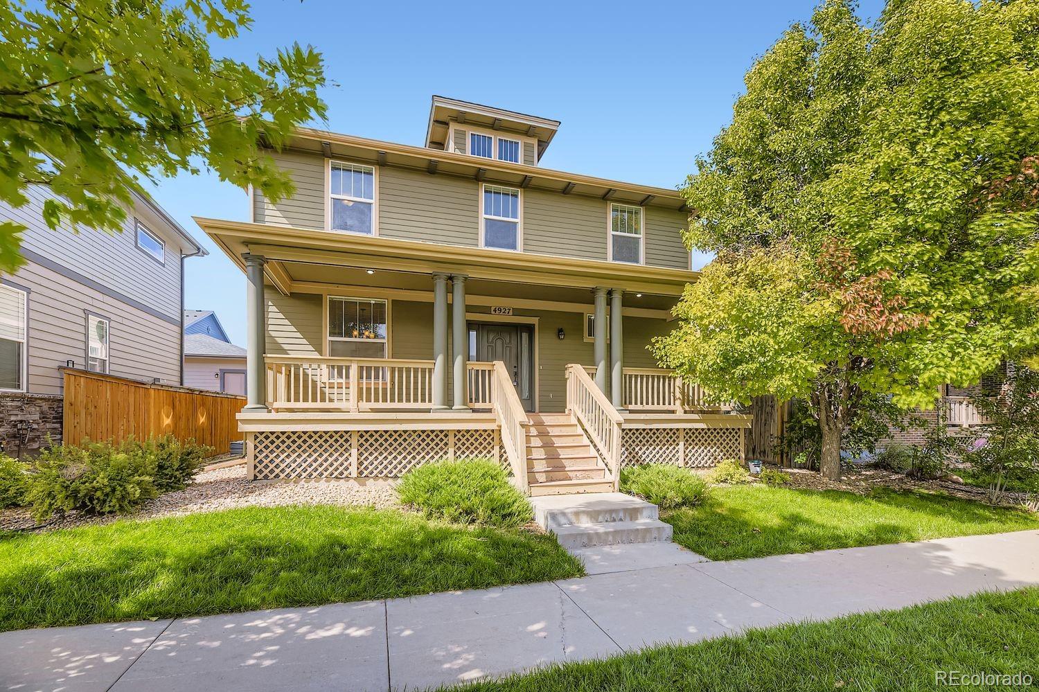 4927 South Addison Way Aurora, CO 80016 - Photo 1 of 24 a front view of a house with garden