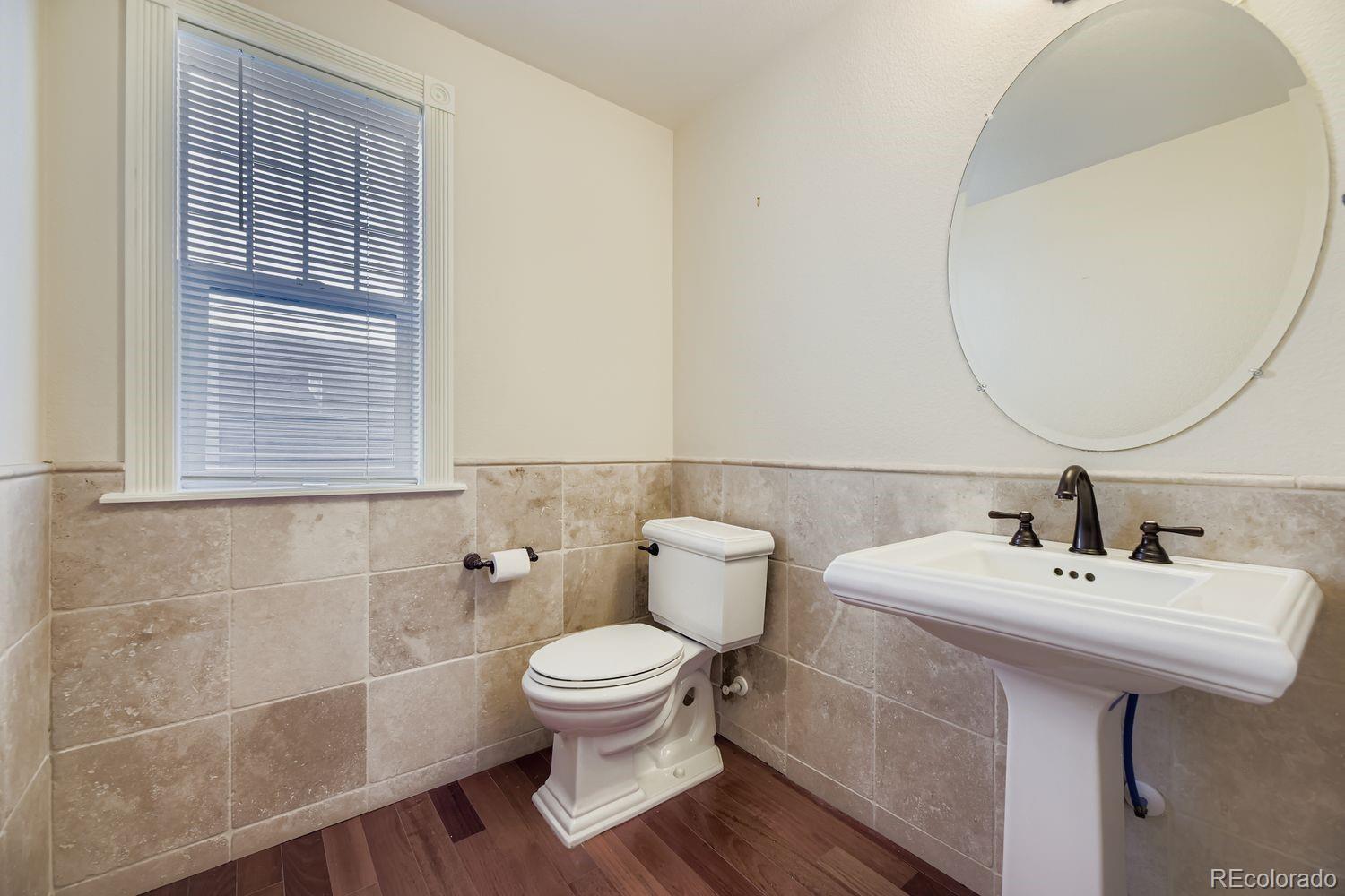 4927 South Addison Way Aurora, CO 80016 - Photo 12 of 24 a bathroom with a sink toilet and a mirror