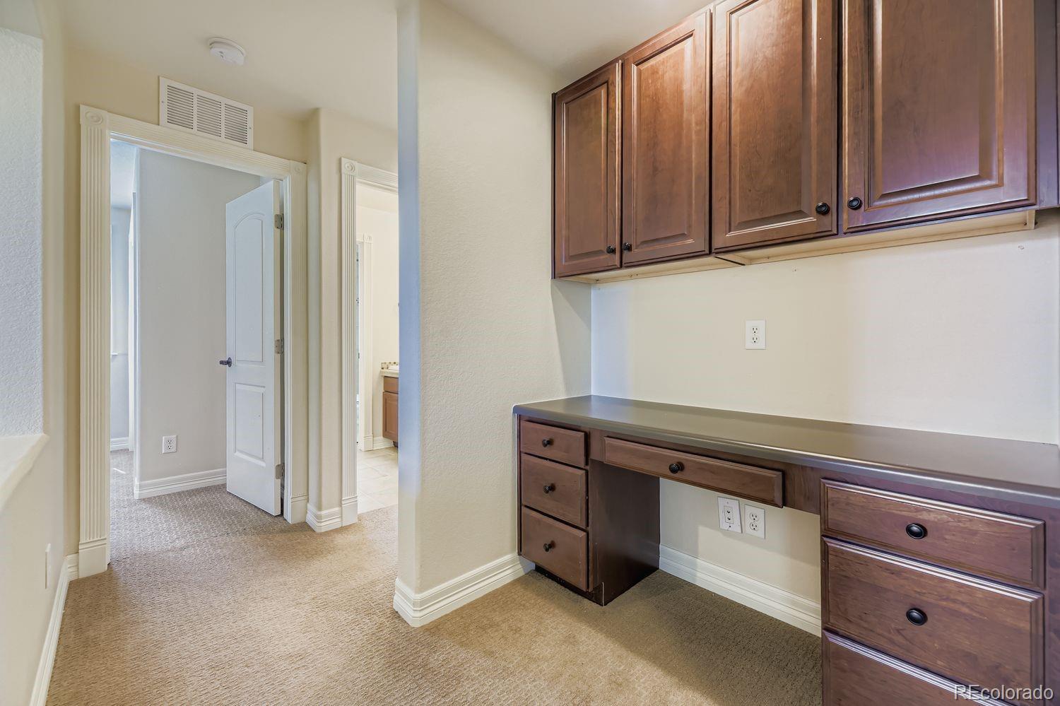 4927 South Addison Way Aurora, CO 80016 - Photo 14 of 24 a view of cabinets with wooden cabinet