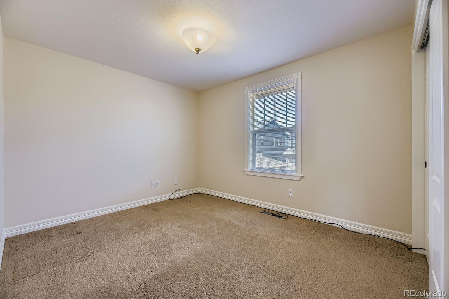 4927 South Addison Way Aurora, CO 80016 - Photo 18 of 24 an empty room with a empty space and windows