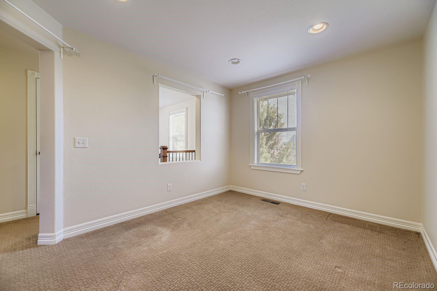 4927 South Addison Way Aurora, CO 80016 - Photo 19 of 24 an empty room with a window