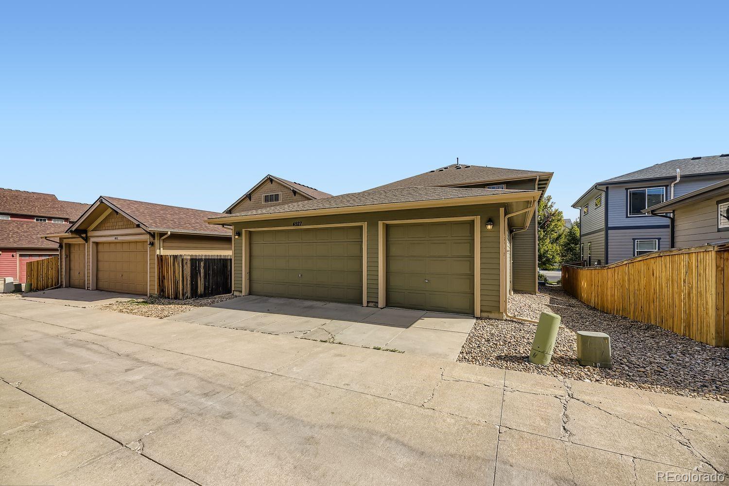 4927 South Addison Way Aurora, CO 80016 - Photo 22 of 24 a front view of a house with a garage