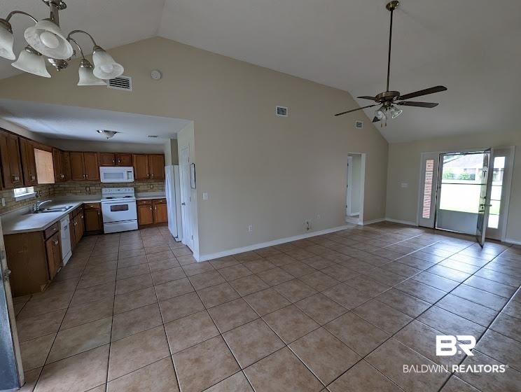 12971 Labradors Run Foley, AL 36535 - Photo 6 of 23 Open-concept living space with vaulted ceilings, neutral wall tones, and ceramic tile flooring throughout