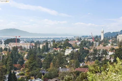 a living room with furniture a large window and wooden floor