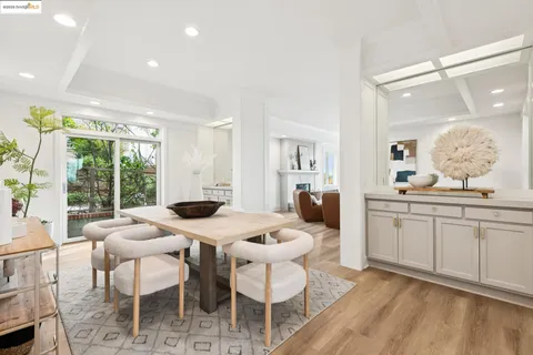 a large white kitchen with a dining table and chairs