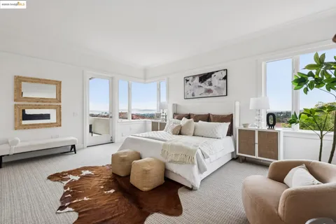 a living room with furniture and a painting on the wall