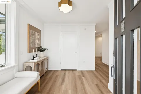 a view of a bedroom with a bed and wooden floor