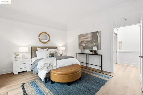 a living room with furniture a rug and kitchen view