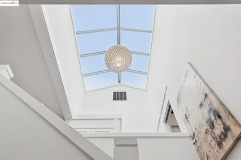 a bedroom with a large bed and a potted plant