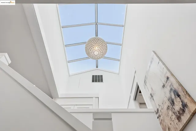 a bedroom with a large bed and a potted plant