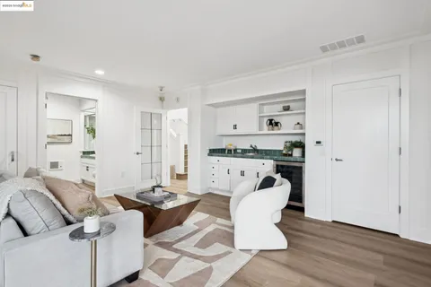 a bathroom with a granite countertop sink a mirror a vanity and a bathtub