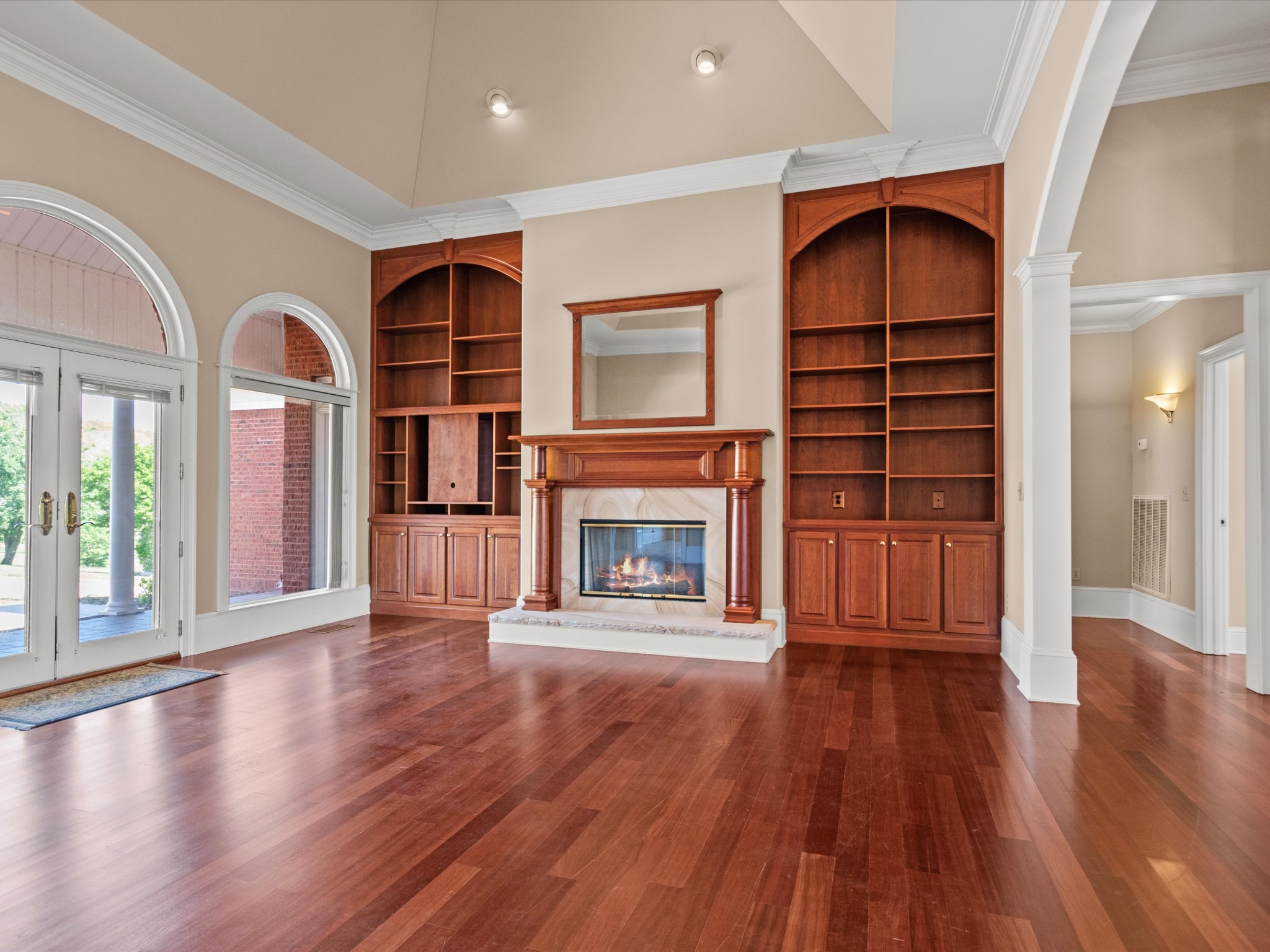 954 Molino Road Taft, TN 38488 - Photo 12 of 64 an empty room with wooden floor fireplace and windows