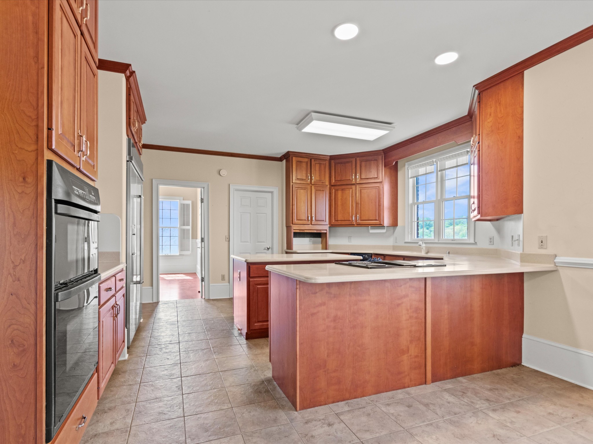 954 Molino Road Taft, TN 38488 - Photo 18 of 64 a kitchen with stainless steel appliances granite countertop a refrigerator a stove and a sink with wooden cabinets