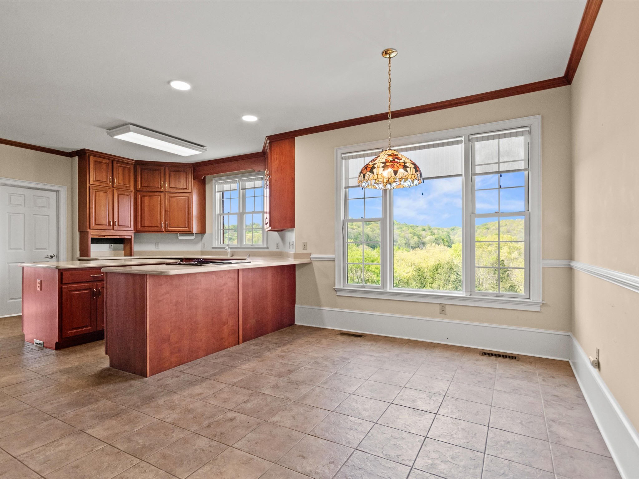 954 Molino Road Taft, TN 38488 - Photo 19 of 64 a kitchen with stainless steel appliances granite countertop a stove a sink and a wooden cabinets