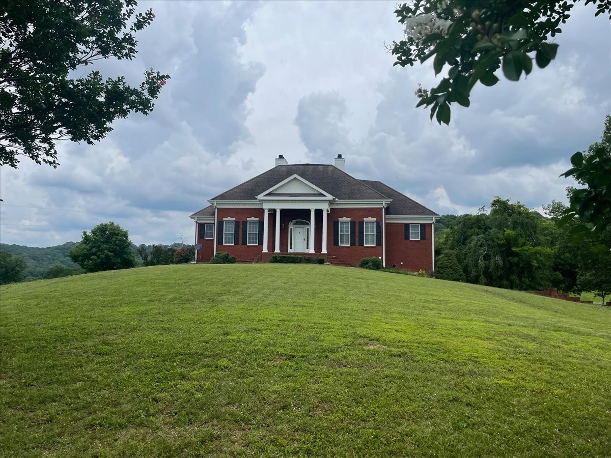 954 Molino Road Taft, TN 38488 - Photo 3 of 64 a front view of a house with a yard