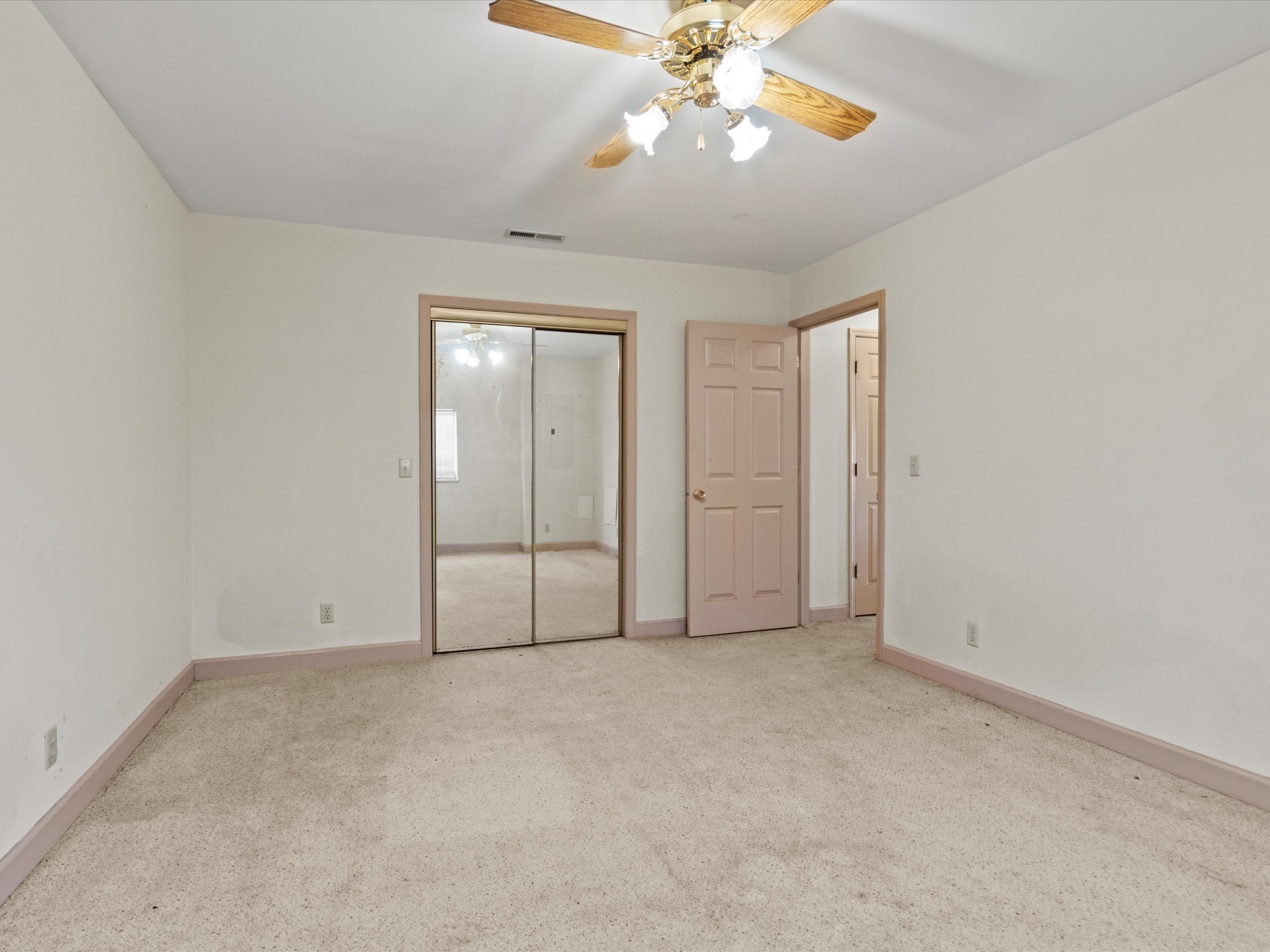 954 Molino Road Taft, TN 38488 - Photo 56 of 64 an empty room with chandelier fan and closet area