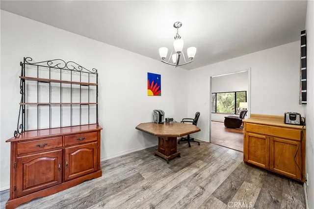 a living room with furniture and paintings on the wall