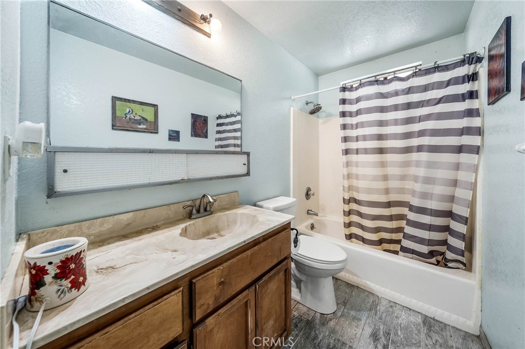 2976 Rancho Vista Drive Lucerne, CA 95458 - Photo 29 of 51 a bathroom with a sink a toilet and a shower curtain