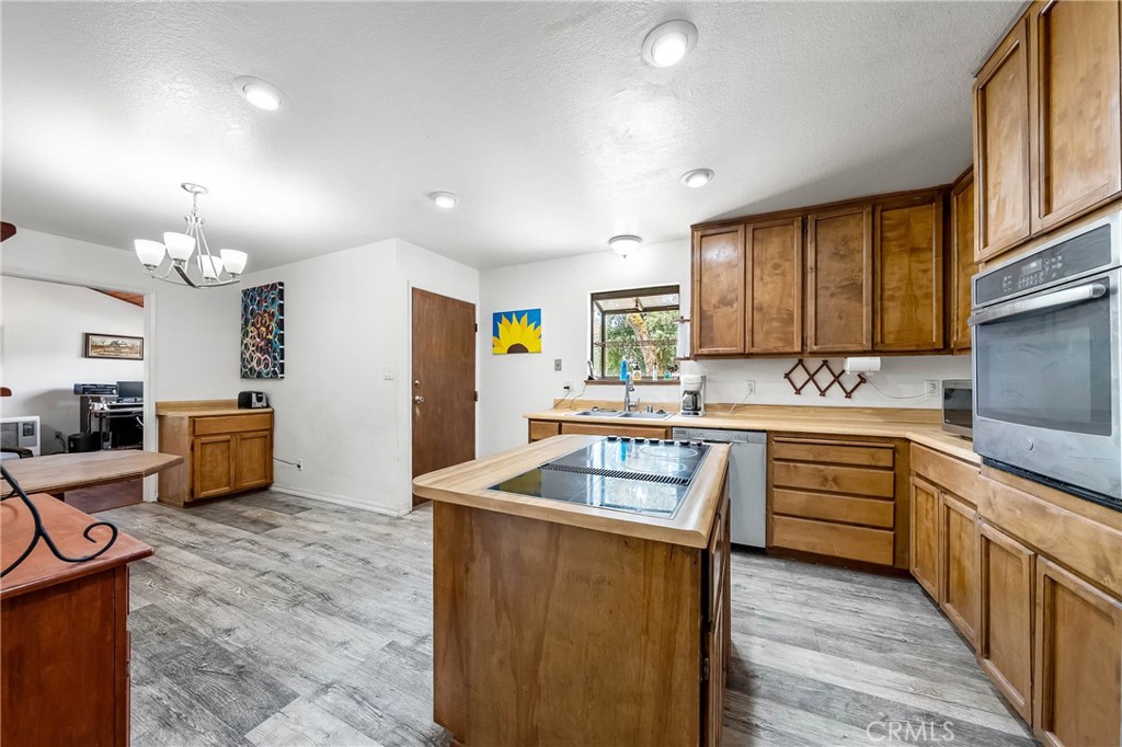 2976 Rancho Vista Drive Lucerne, CA 95458 - Photo 41 of 51 a kitchen with granite countertop a sink stove and cabinets
