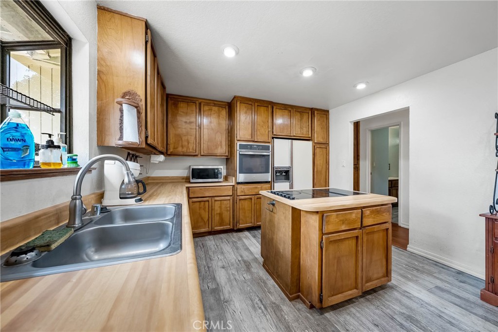 2976 Rancho Vista Drive Lucerne, CA 95458 - Photo 50 of 51 a kitchen with a stove sink and a refrigerator