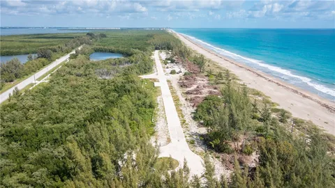 a view of beach and hall with wooden floor