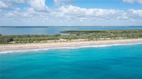 an aerial view of a house with garden space and street view