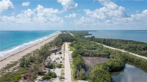 a view of a patio with table and chairs with wooden floor and fence