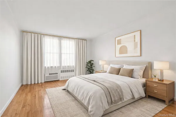 a bedroom with a large bed and a large window