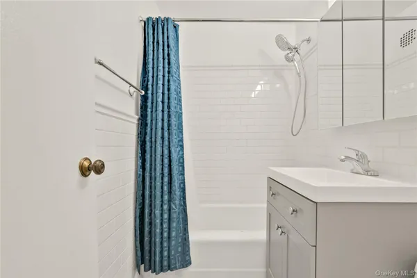 a bathroom with a shower and a sink