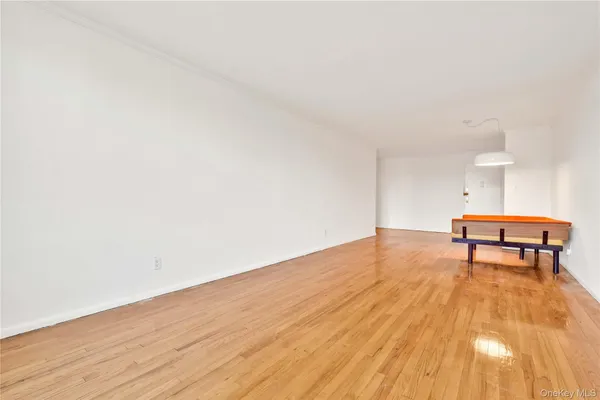 a view of a room with wooden floor and bench