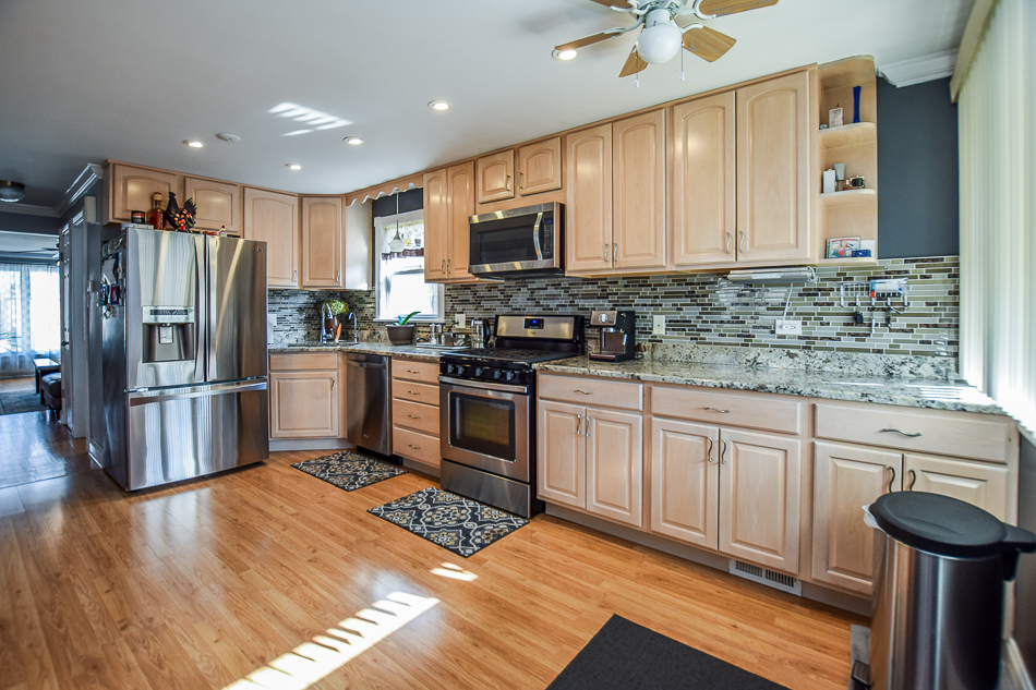 5104 South Rutherford Avenue Chicago, IL 60638 - Photo 14 of 23 a kitchen with granite countertop a refrigerator stove top oven and sink