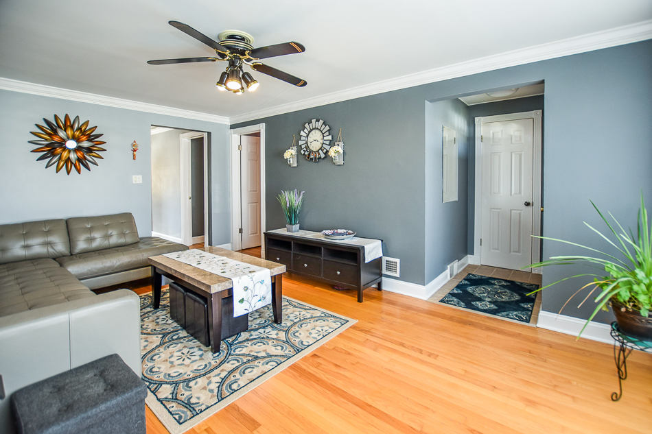 5104 South Rutherford Avenue Chicago, IL 60638 - Photo 3 of 23 a living room with furniture and a chandelier