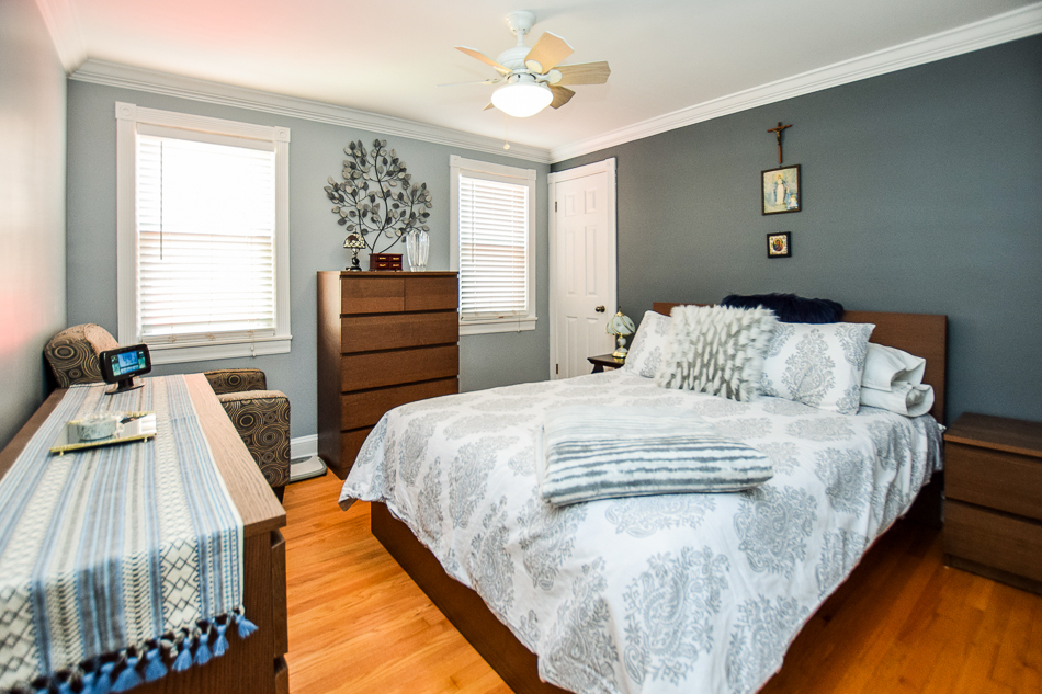 5104 South Rutherford Avenue Chicago, IL 60638 - Photo 5 of 23 a bedroom with a bed and a flat tv screen on the dresser