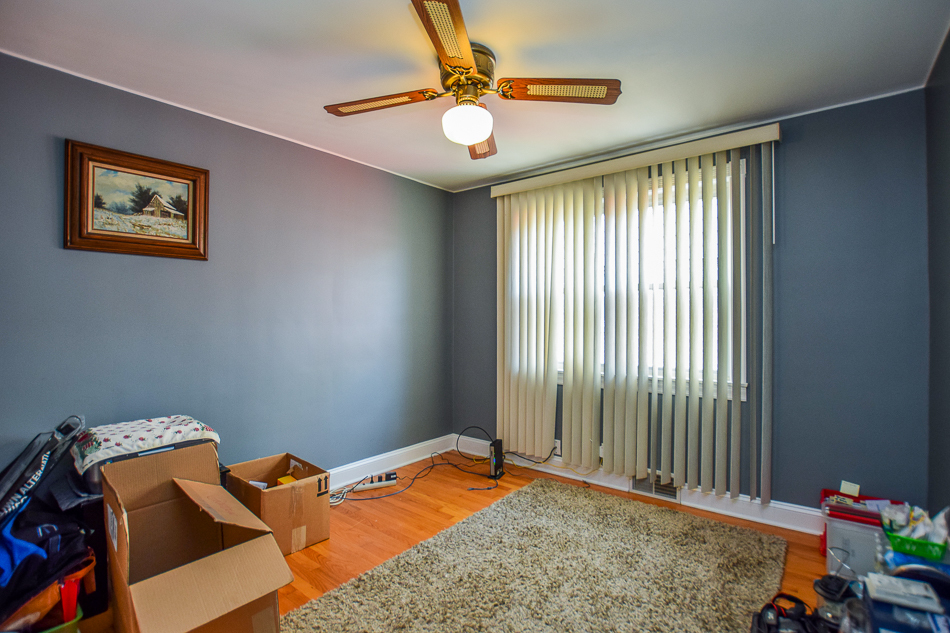 5104 South Rutherford Avenue Chicago, IL 60638 - Photo 6 of 23 a bedroom with bed and a window