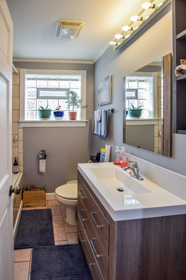 5104 South Rutherford Avenue Chicago, IL 60638 - Photo 7 of 23 a bathroom with a sink a toilet a mirror and window