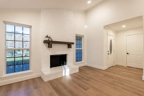 a view of a livingroom with a fireplace and window