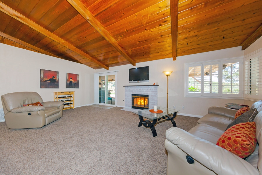 9276 High Rise Way Santee, CA 92071 - Photo 2 of 24 Feel the warmth in the Living room from the wood-beamed vaulted ceilings to the fire on ice fireplace!