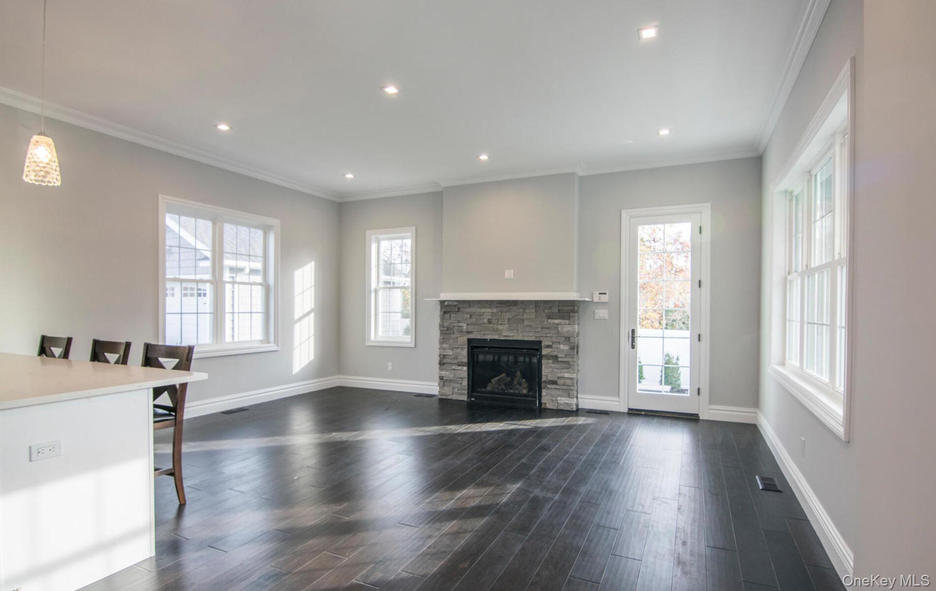 2 Seaman Road Glen Cove, NY 11542 - Photo 4 of 17 Living room with fireplace side door to the patio for alfresco dining.