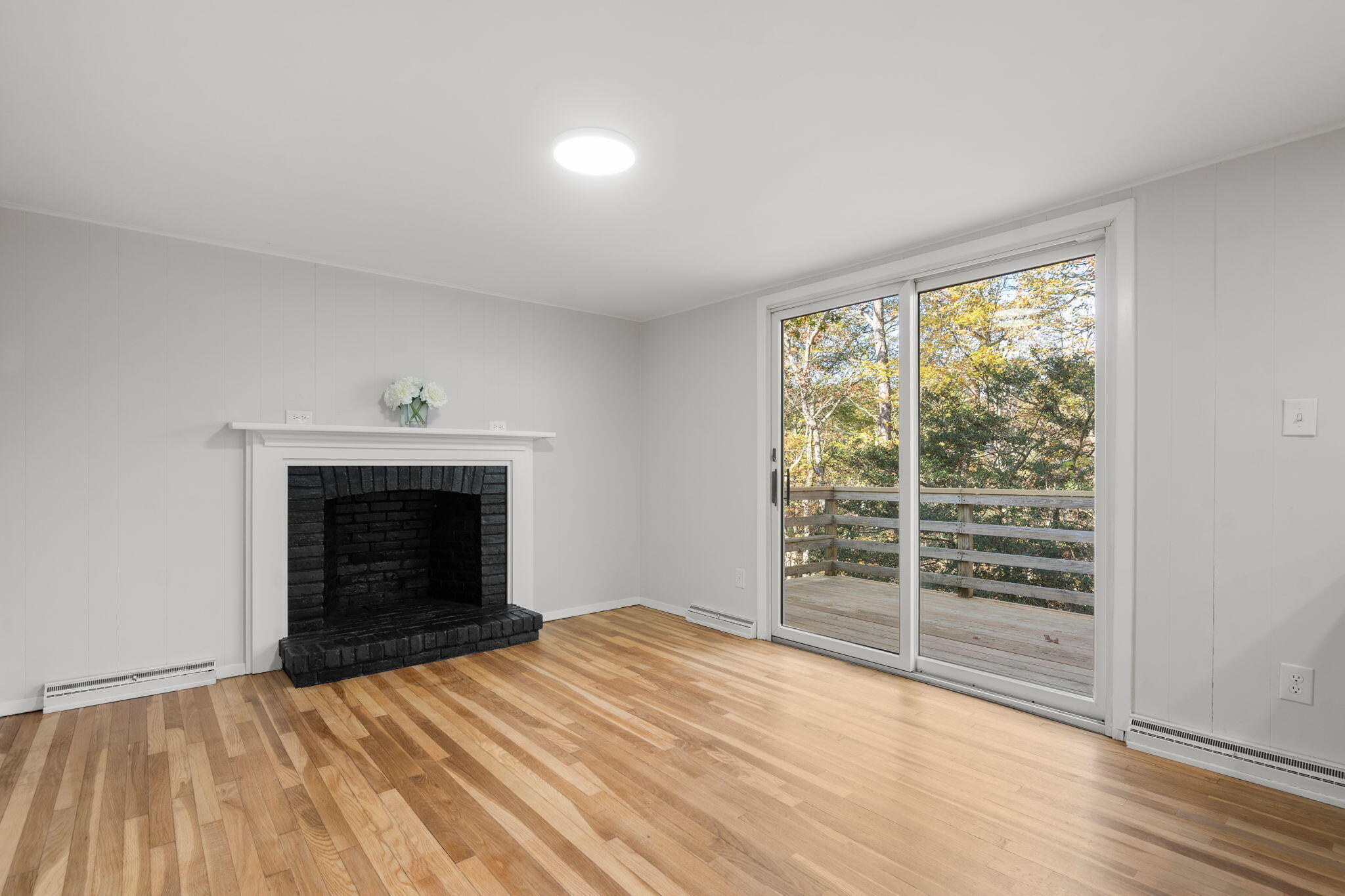 118 Fox Hill Road Centerville, MA 02632 - Photo 13 of 22 a view of empty room with wooden floor and fireplace