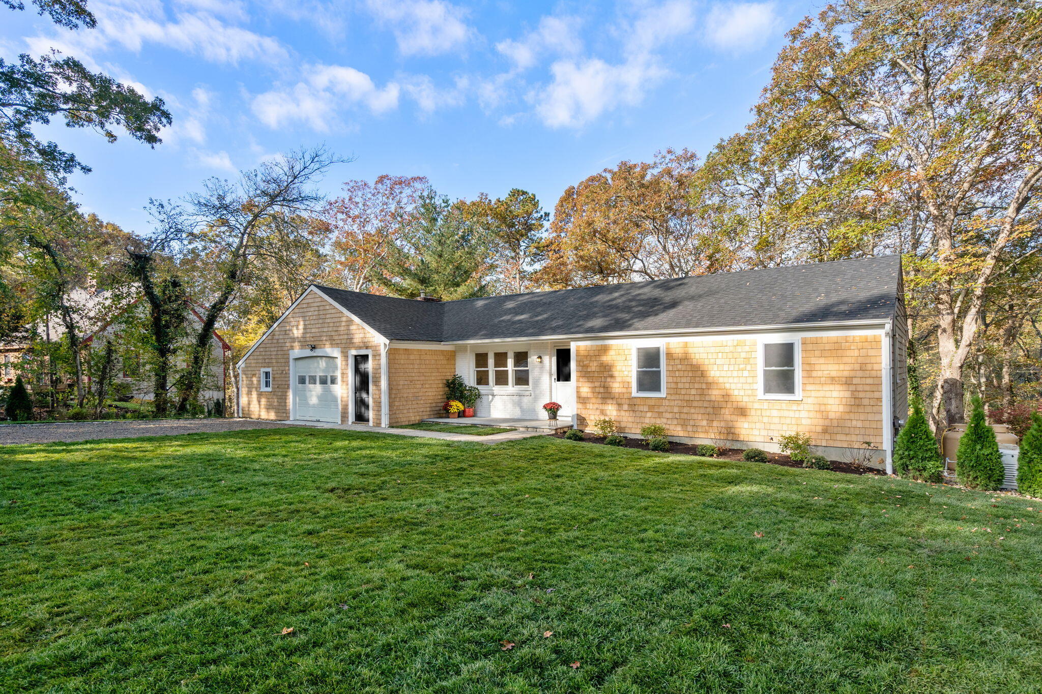 118 Fox Hill Road Centerville, MA 02632 - Photo 2 of 22 a front view of a house with a garden