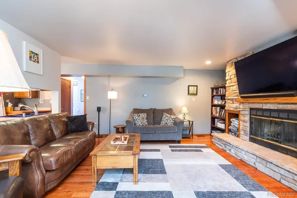 a living room with furniture and a fireplace