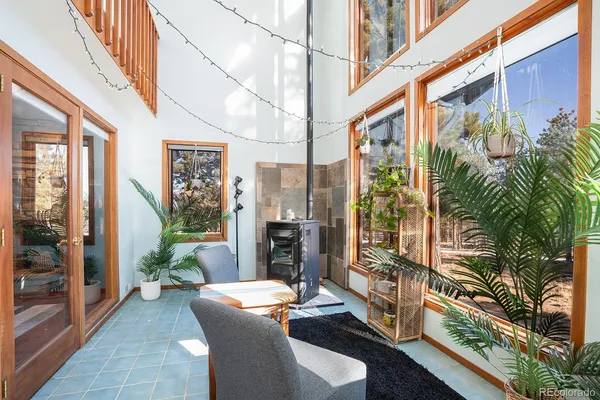 a living room with furniture and a floor to ceiling window