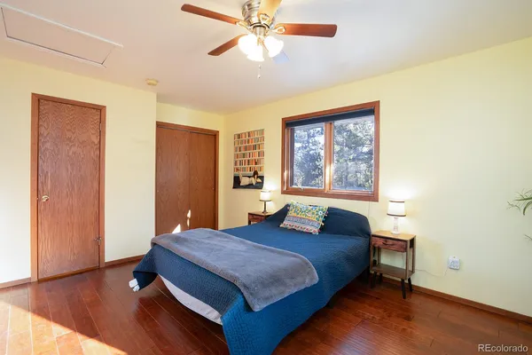 a spacious bedroom with a bed and a large window