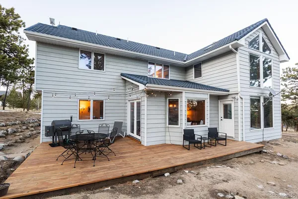 a view of a house with a mountain and a forest
