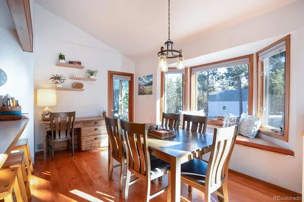 a view of a dining room with furniture window and wooden floor