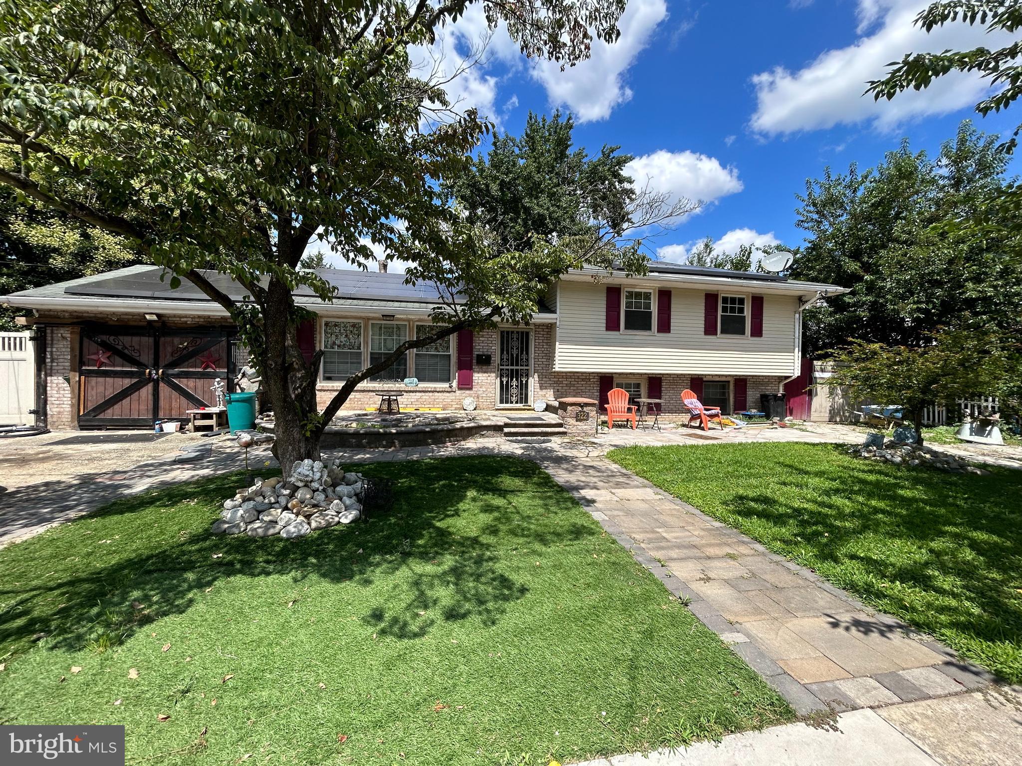 322 Nicholson Road Mount Ephraim, NJ 08059 - Photo 1 of 1 a front view of a house with a garden and trees