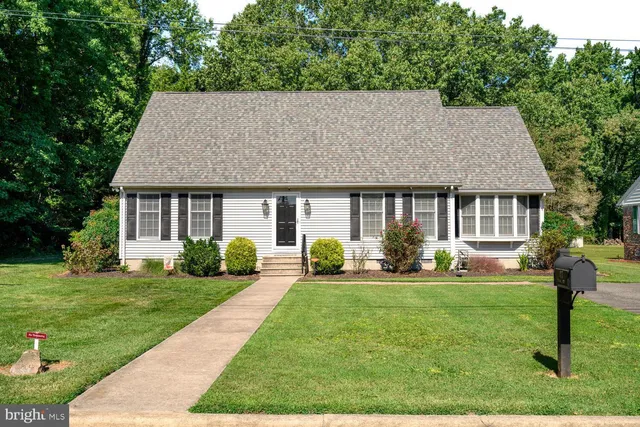 a front view of a house with a yard and porch