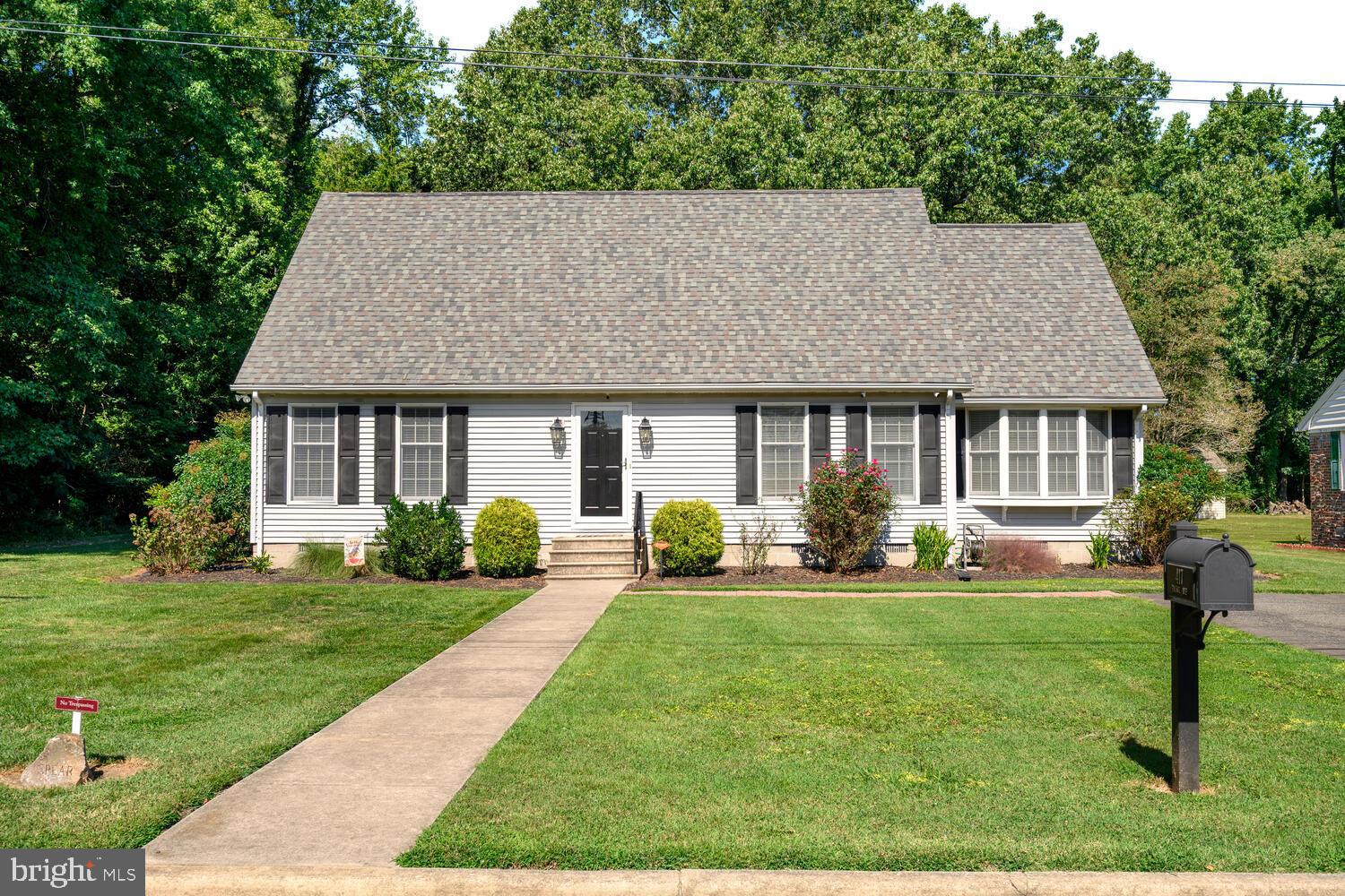 a front view of a house with a yard and porch