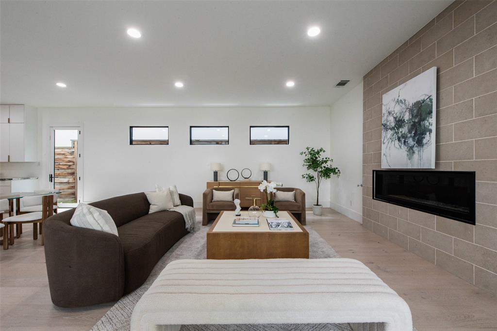 6443 Kenwood Avenue Dallas, TX 75214 - Photo 9 of 21 Living area featuring light wood finished floors, a tiled fireplace, and recessed lighting